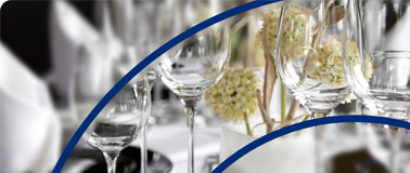 Clean wine glasses sit on a fine dining table