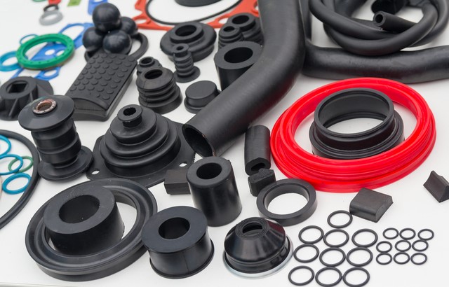 Assorted gaskets and hoses spread out on a blank white background