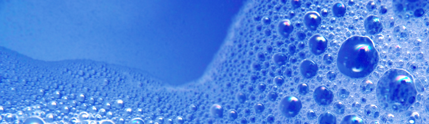 Foamy bubbles in water over a blue background