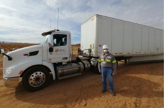 Univar Solutions employee standing in front of a Navajo Nation water distribution truck
