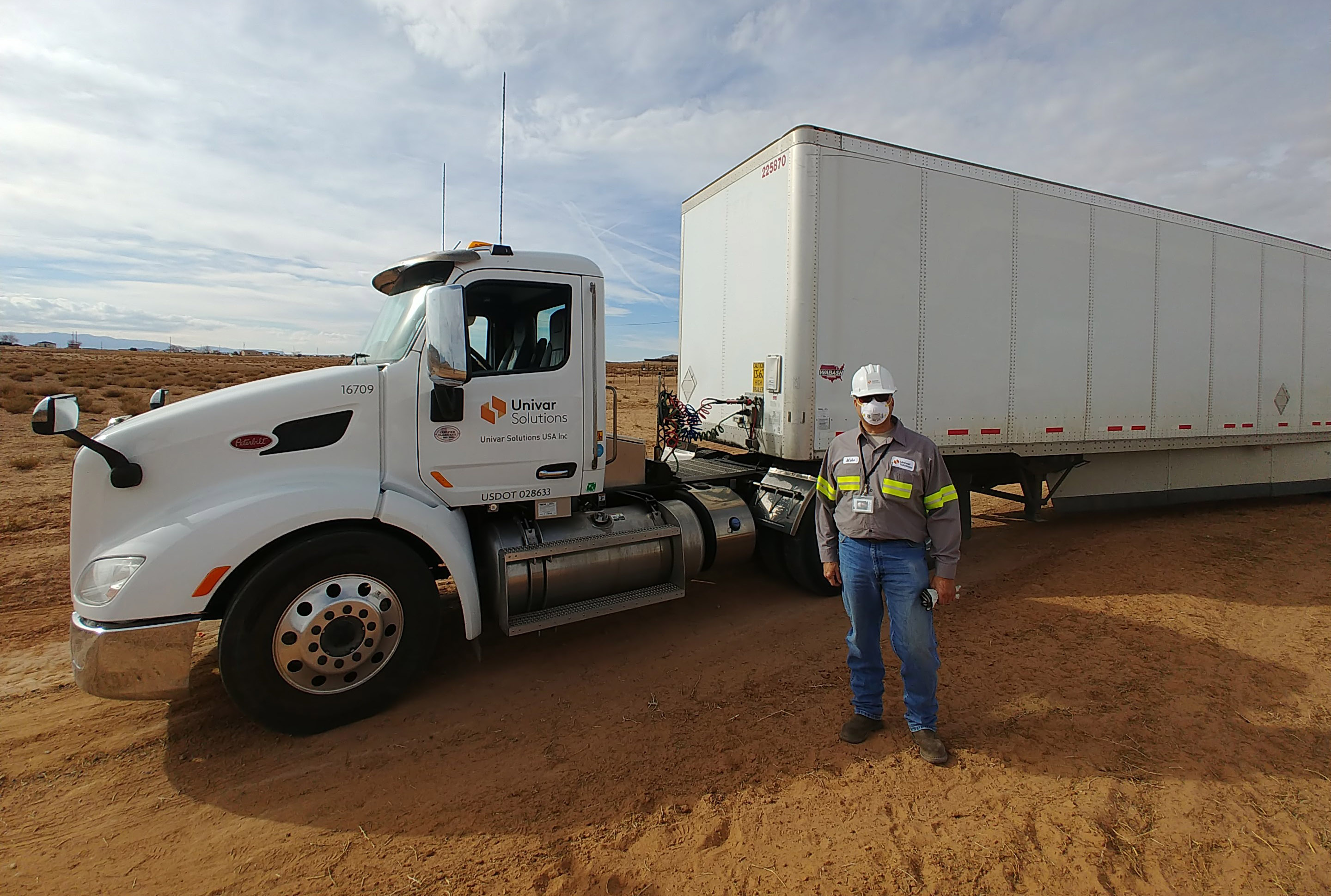 Univar Solutions employee standing in front of a Navajo Nation water distribution truck