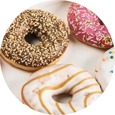 Three gourmet donuts with icing and toppings