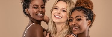 A diverse group of smiling women with radient skin