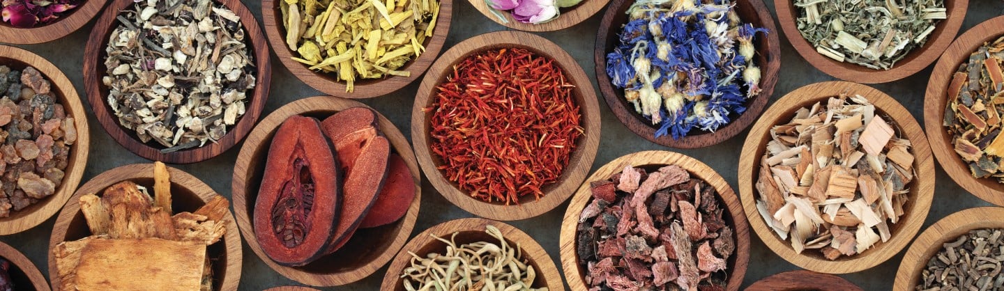 variety of herbal supplements in wooden bowls