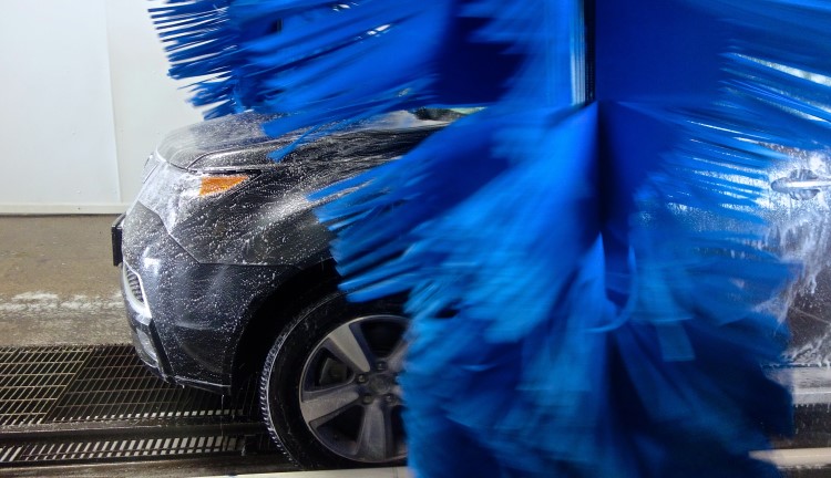 Car wash drying brushes move in motion during a tunnel car wash