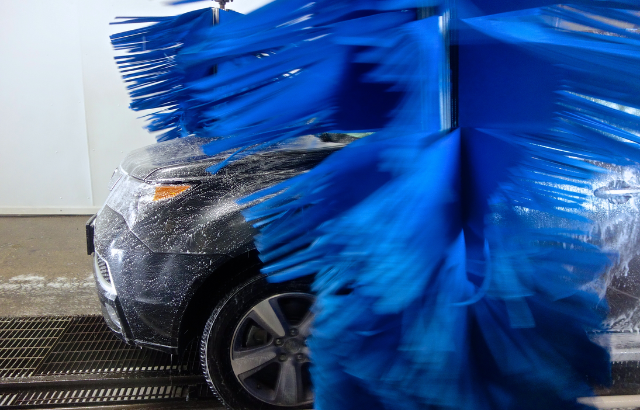 Black car entering into a car wash