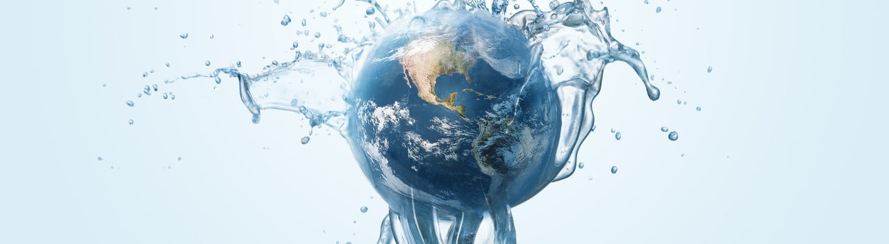 A globe of Earth with a stream of clean water coming up from the bottom and splashing over the Earth. 