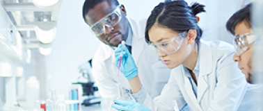 Three scientist in a laboratory testing formulatoins