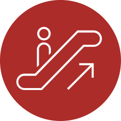 Red circle with a white outline of a person going up an escalator