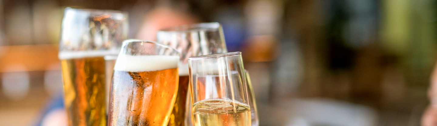 four beer glasses coming together to cheers