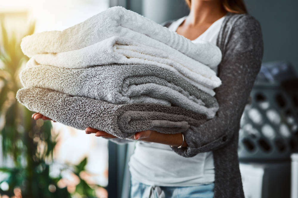 person holing three folded towels