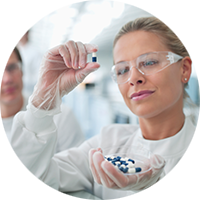 Lab technician inspecting pharmacuetical ingredients