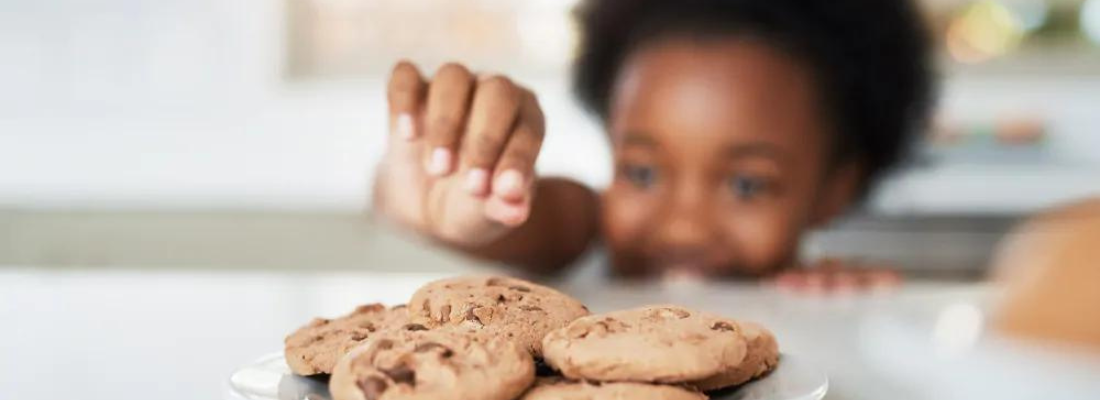 child reaching for a cookie