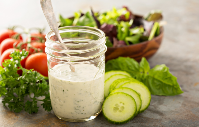 homemade salad dressing surrounded by veggies