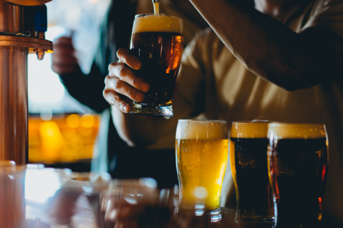 Person dispensing beer into a glass