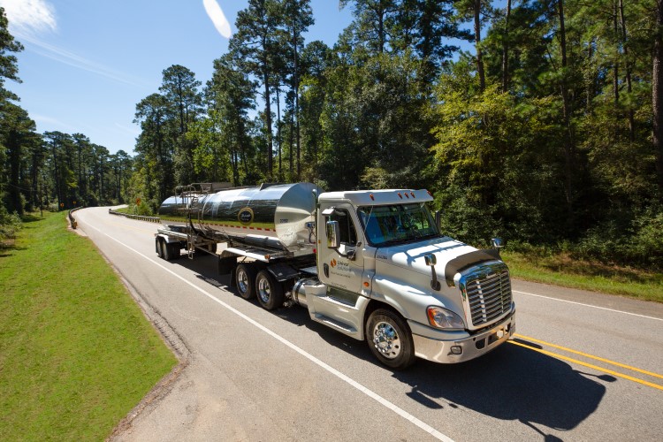 A Univar Solutions tanker truck drives on a roadway