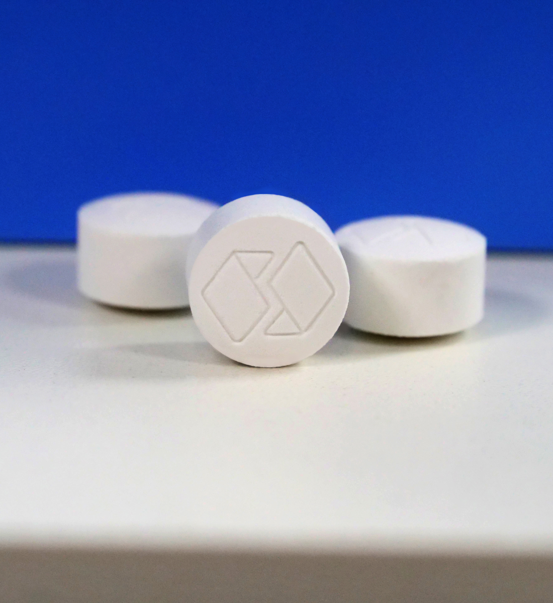 three pills with one facing up and displaying Univar Solutions logo