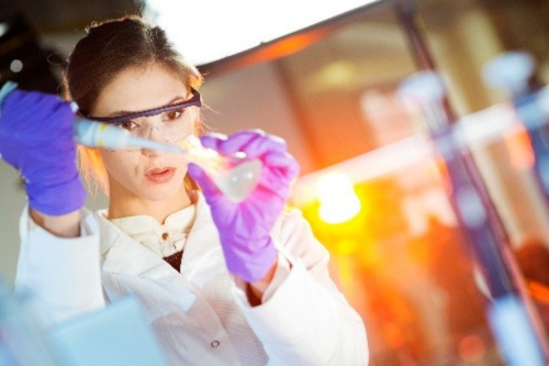woman in a lab measuring a substance