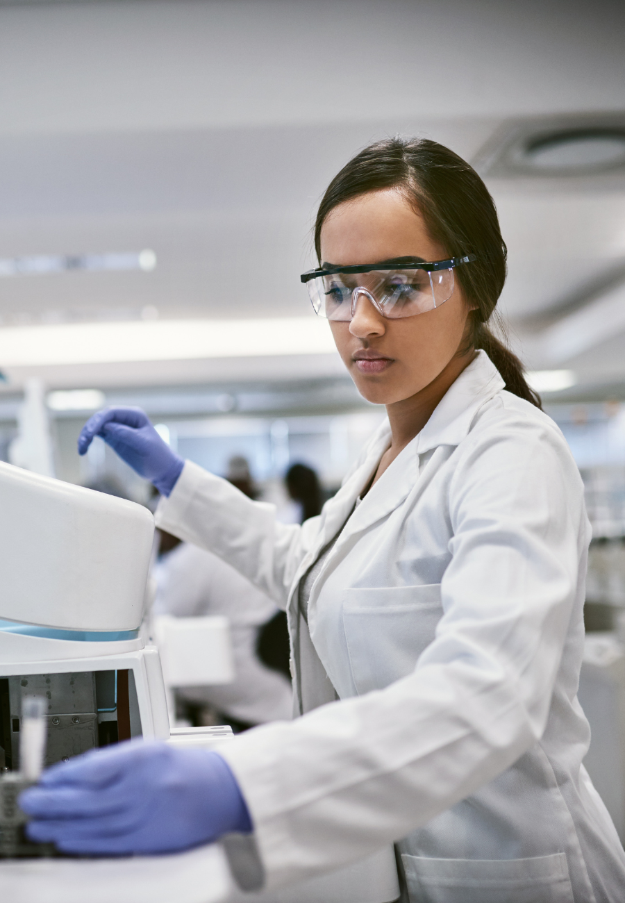 A pharma ingredient specialist works on pharmaceutical formulation development in a specialty laboratory space.